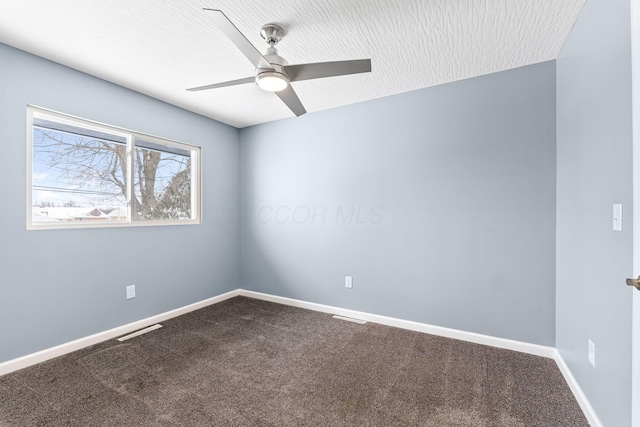 carpeted spare room with ceiling fan