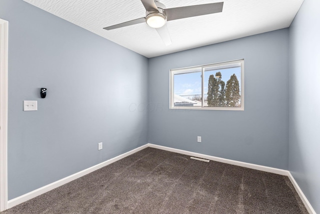 carpeted spare room with a textured ceiling and ceiling fan