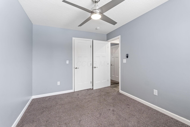 unfurnished bedroom featuring carpet flooring, a textured ceiling, and ceiling fan