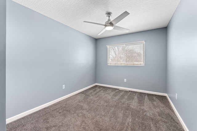 carpeted spare room with ceiling fan and a textured ceiling