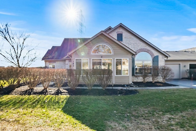 view of front facade with a garage and a front lawn