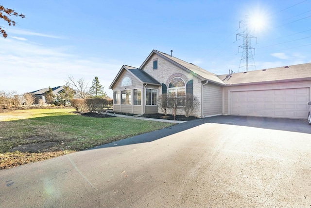 single story home featuring a garage and a front yard