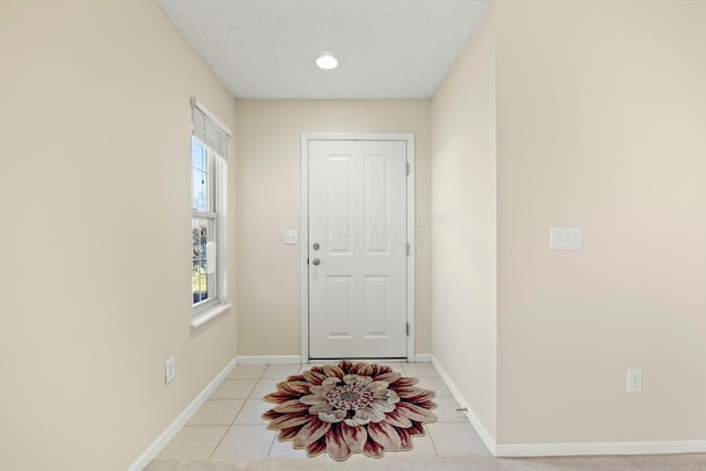 doorway with light tile patterned floors