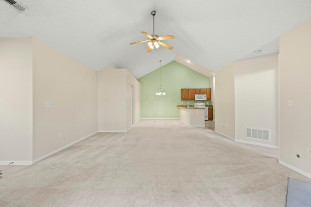 unfurnished living room featuring lofted ceiling, ceiling fan with notable chandelier, and light carpet