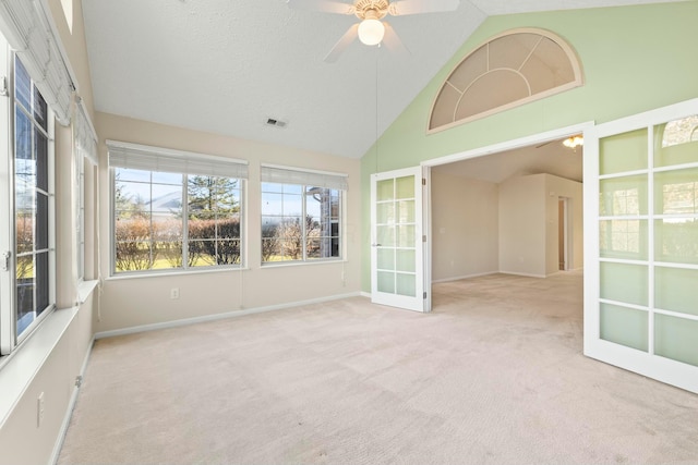 unfurnished sunroom featuring lofted ceiling, french doors, and ceiling fan