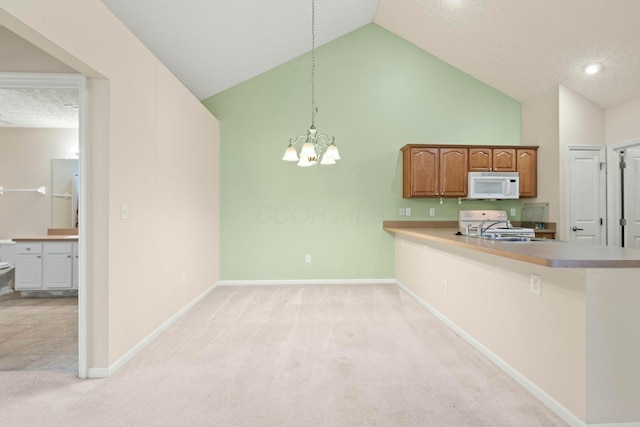 kitchen featuring sink, hanging light fixtures, stove, kitchen peninsula, and light carpet