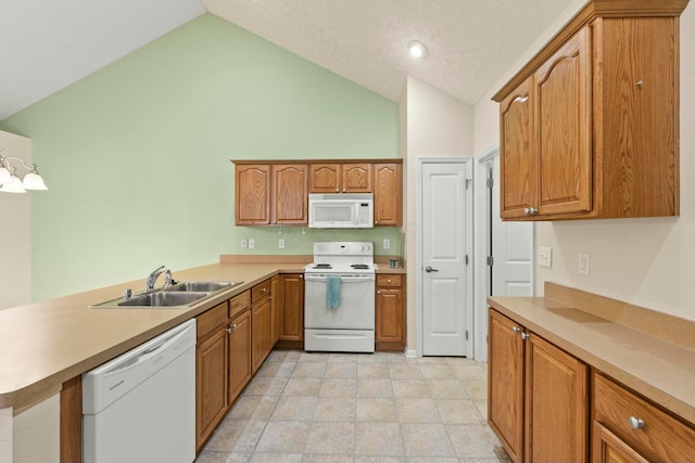 kitchen with lofted ceiling, sink, white appliances, kitchen peninsula, and a textured ceiling