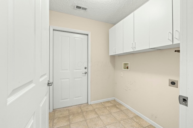 laundry room with cabinets, hookup for a washing machine, hookup for an electric dryer, and a textured ceiling