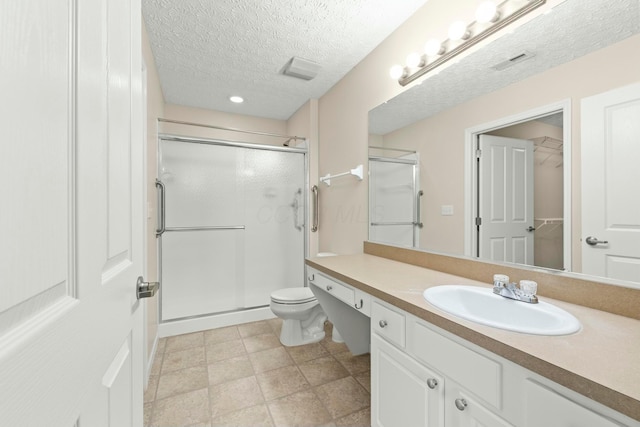 bathroom featuring vanity, toilet, a textured ceiling, and walk in shower