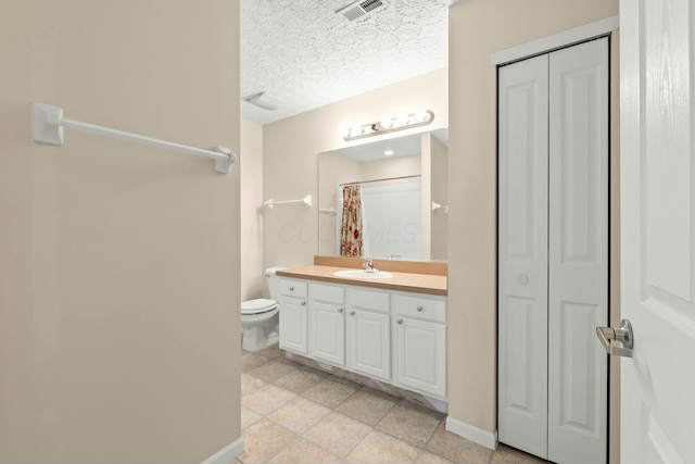 bathroom with walk in shower, vanity, toilet, and a textured ceiling