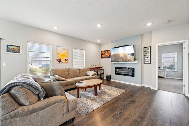 living room with a healthy amount of sunlight and dark hardwood / wood-style flooring