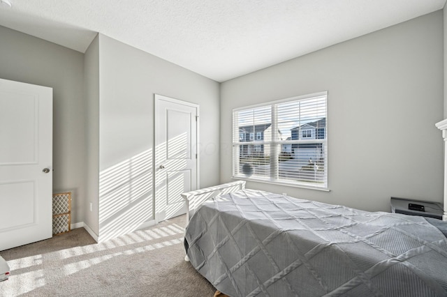 carpeted bedroom featuring a textured ceiling