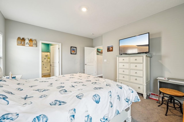 bedroom featuring ensuite bathroom and light colored carpet