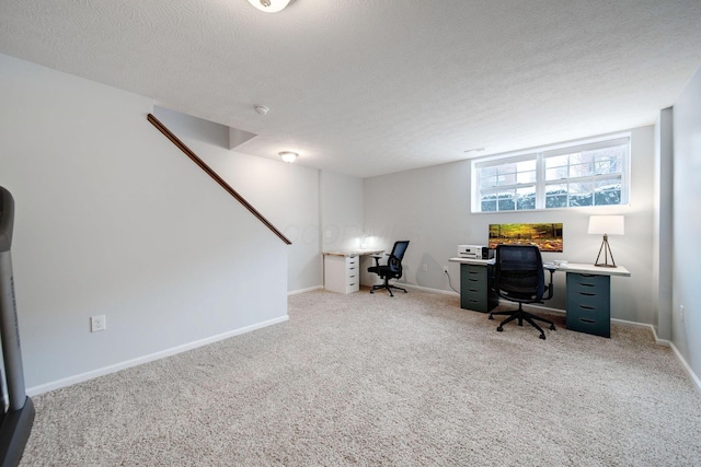 carpeted office with a textured ceiling