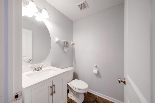 bathroom featuring tile patterned floors, vanity, and toilet