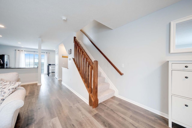 staircase featuring hardwood / wood-style floors