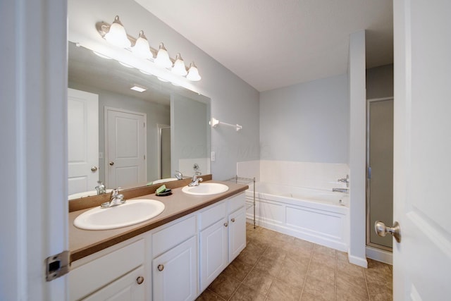 bathroom featuring vanity and independent shower and bath