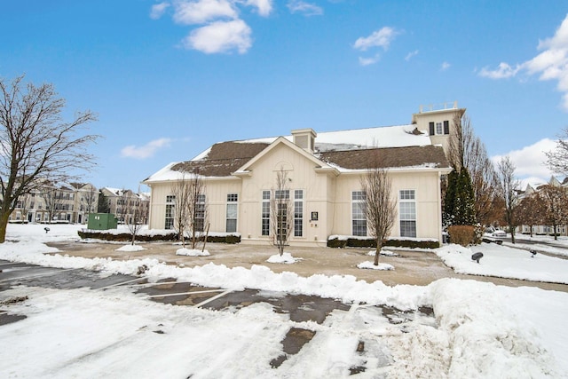 view of snow covered rear of property