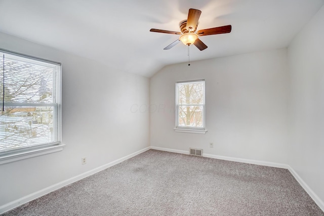 carpeted empty room with lofted ceiling and ceiling fan