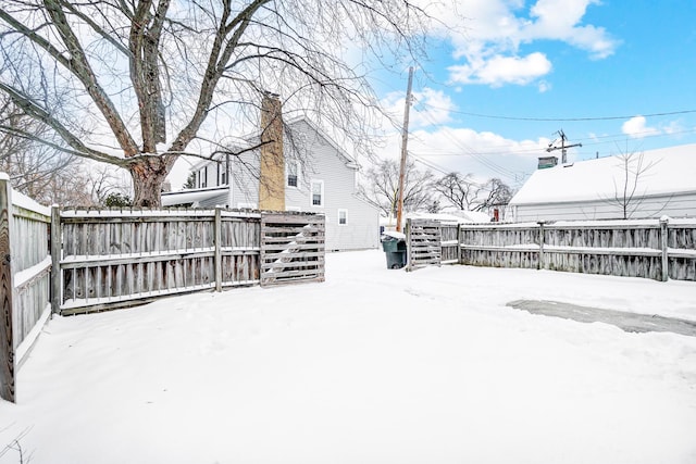 view of yard layered in snow