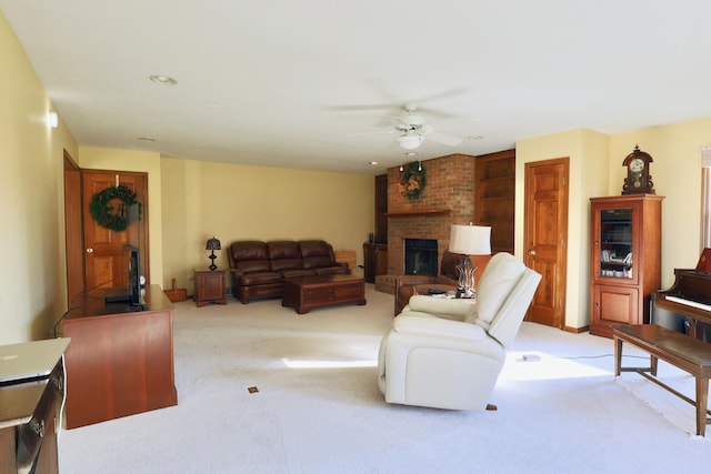 living room featuring light carpet, ceiling fan, and a brick fireplace