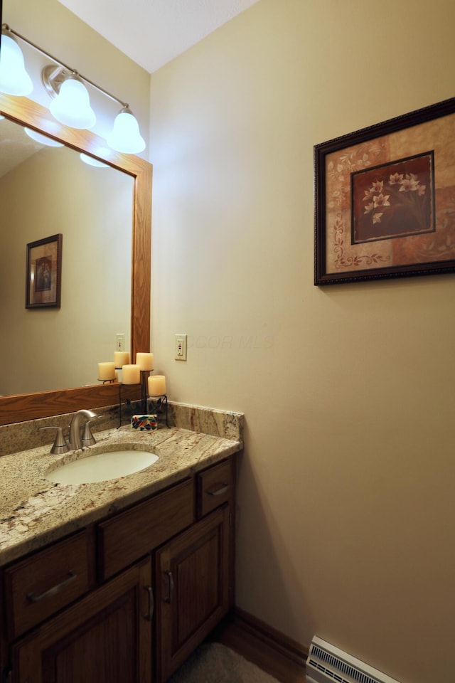 bathroom with vanity and baseboard heating