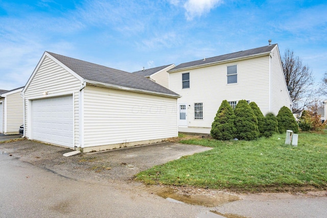 view of side of home with a yard and a garage