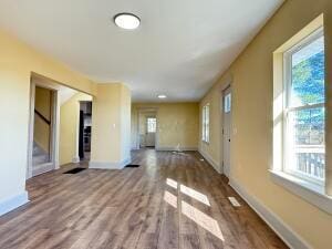 unfurnished living room with wood-type flooring