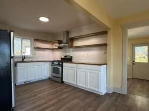 kitchen featuring dark wood-type flooring, white cabinets, sink, wall chimney exhaust hood, and stainless steel appliances