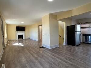 unfurnished living room with dark hardwood / wood-style floors