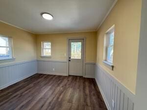 entryway featuring dark hardwood / wood-style floors and crown molding