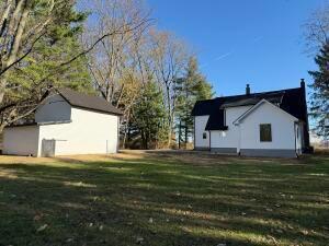 view of property exterior featuring a lawn