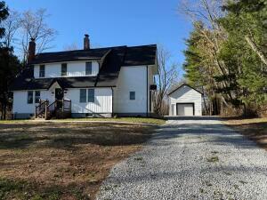 view of front of home with an outbuilding and a garage