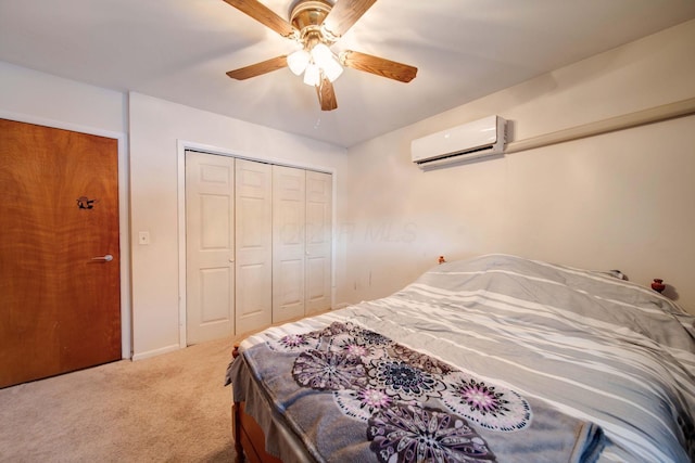 bedroom featuring ceiling fan, carpet, a closet, and a wall unit AC