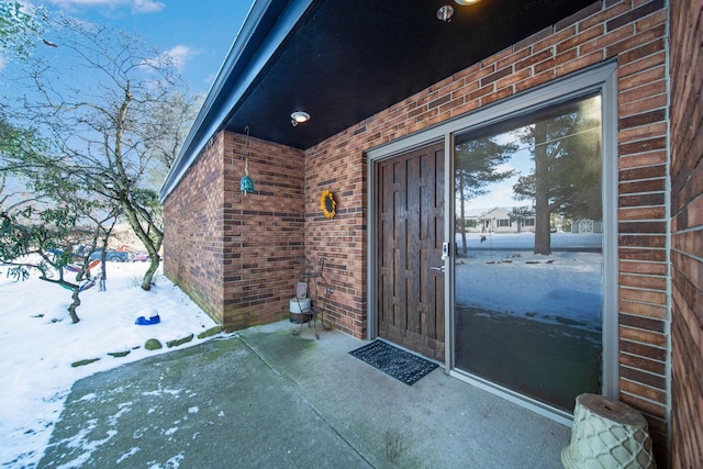 view of snow covered property entrance