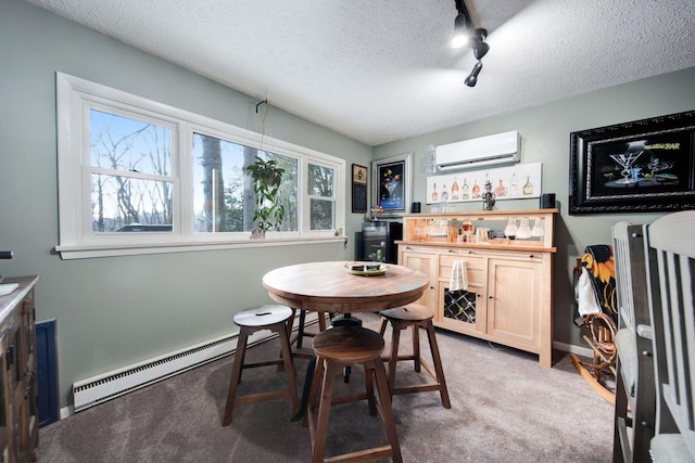 carpeted dining area featuring indoor bar, a wall mounted air conditioner, track lighting, a textured ceiling, and baseboard heating