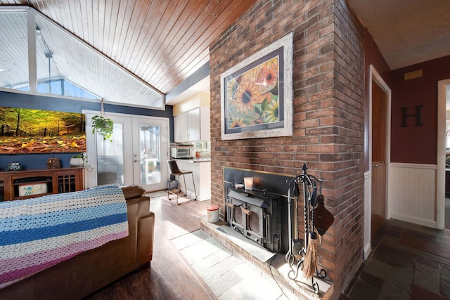 living room with lofted ceiling, french doors, and wood ceiling