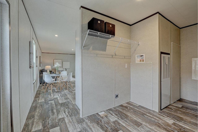 corridor featuring ornamental molding and hardwood / wood-style flooring