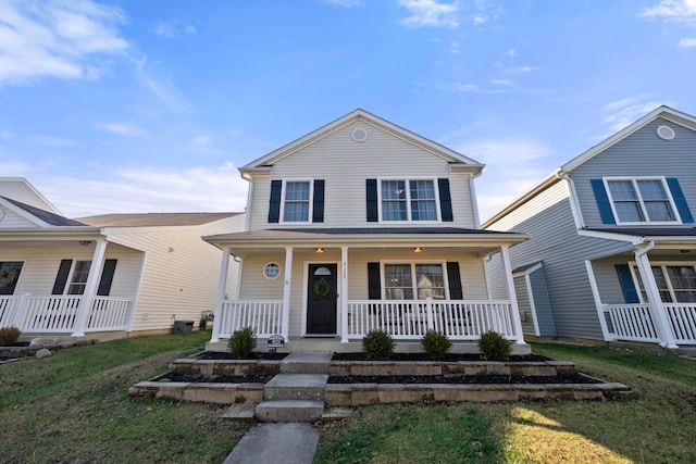 view of front of property featuring covered porch and a front yard