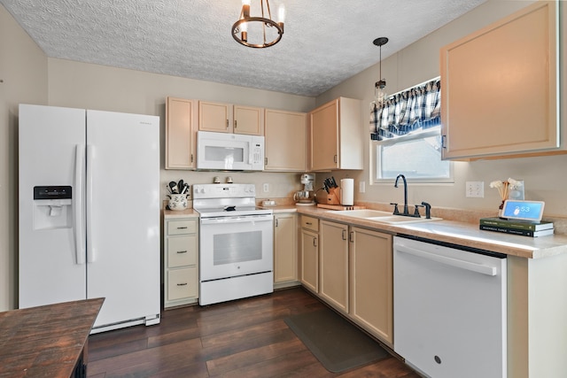 kitchen featuring decorative light fixtures, sink, white appliances, and a textured ceiling