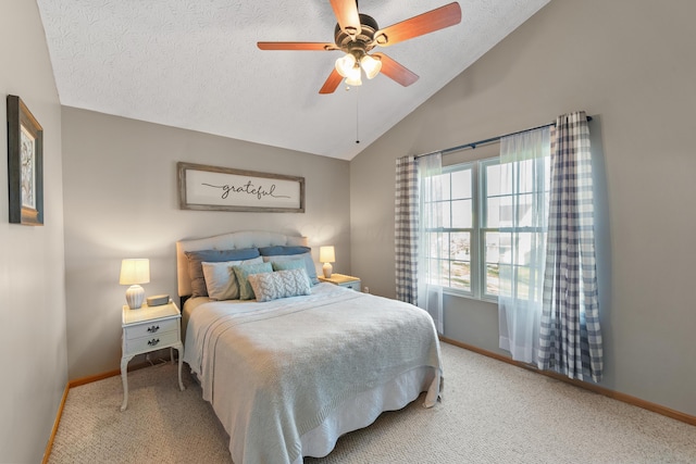 bedroom with carpet flooring, a textured ceiling, vaulted ceiling, and ceiling fan