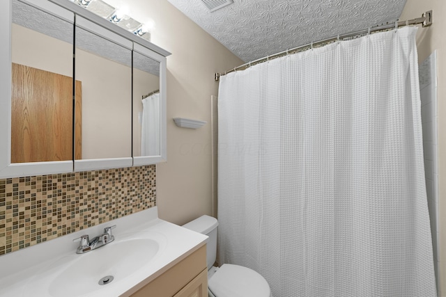 bathroom with walk in shower, backsplash, a textured ceiling, toilet, and vanity