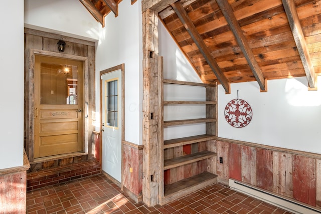 stairway with baseboard heating, wooden walls, lofted ceiling with beams, and wooden ceiling