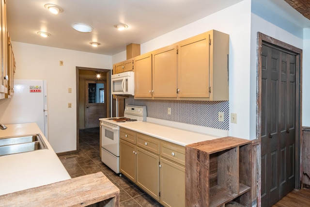 kitchen featuring tasteful backsplash, white appliances, light brown cabinetry, and sink