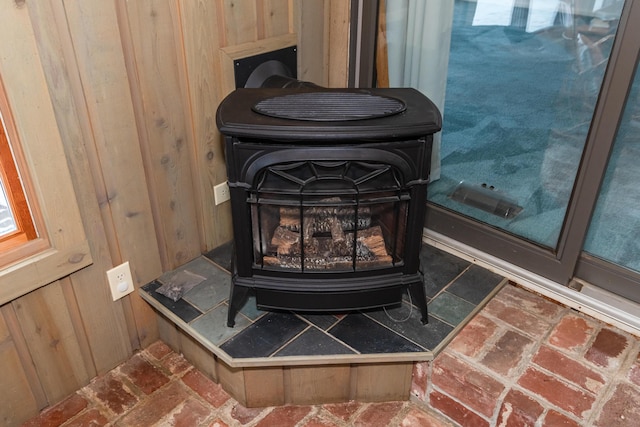 details with wooden walls and a wood stove