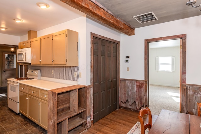 kitchen featuring dark carpet, white appliances, beamed ceiling, and light brown cabinets