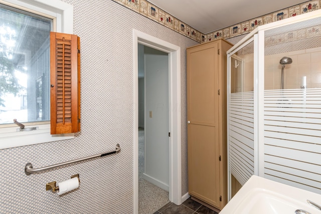 bathroom with tile patterned floors and walk in shower