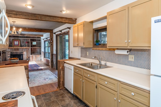 kitchen featuring sink, white appliances, a fireplace, decorative light fixtures, and beamed ceiling