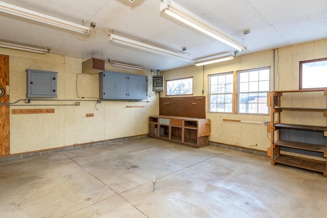 garage featuring electric panel and a workshop area