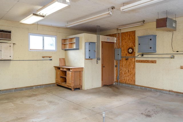 garage with a wall mounted air conditioner and electric panel